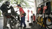 Petugas SPBU melayani pelanggan mengisi BBM